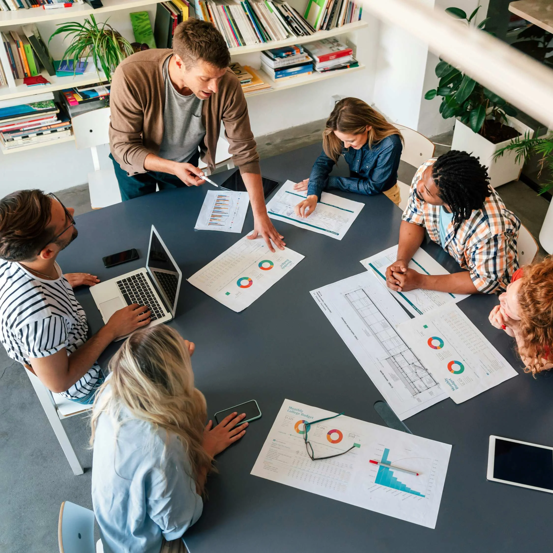 Team collaborating at desk during Shopify store planning session