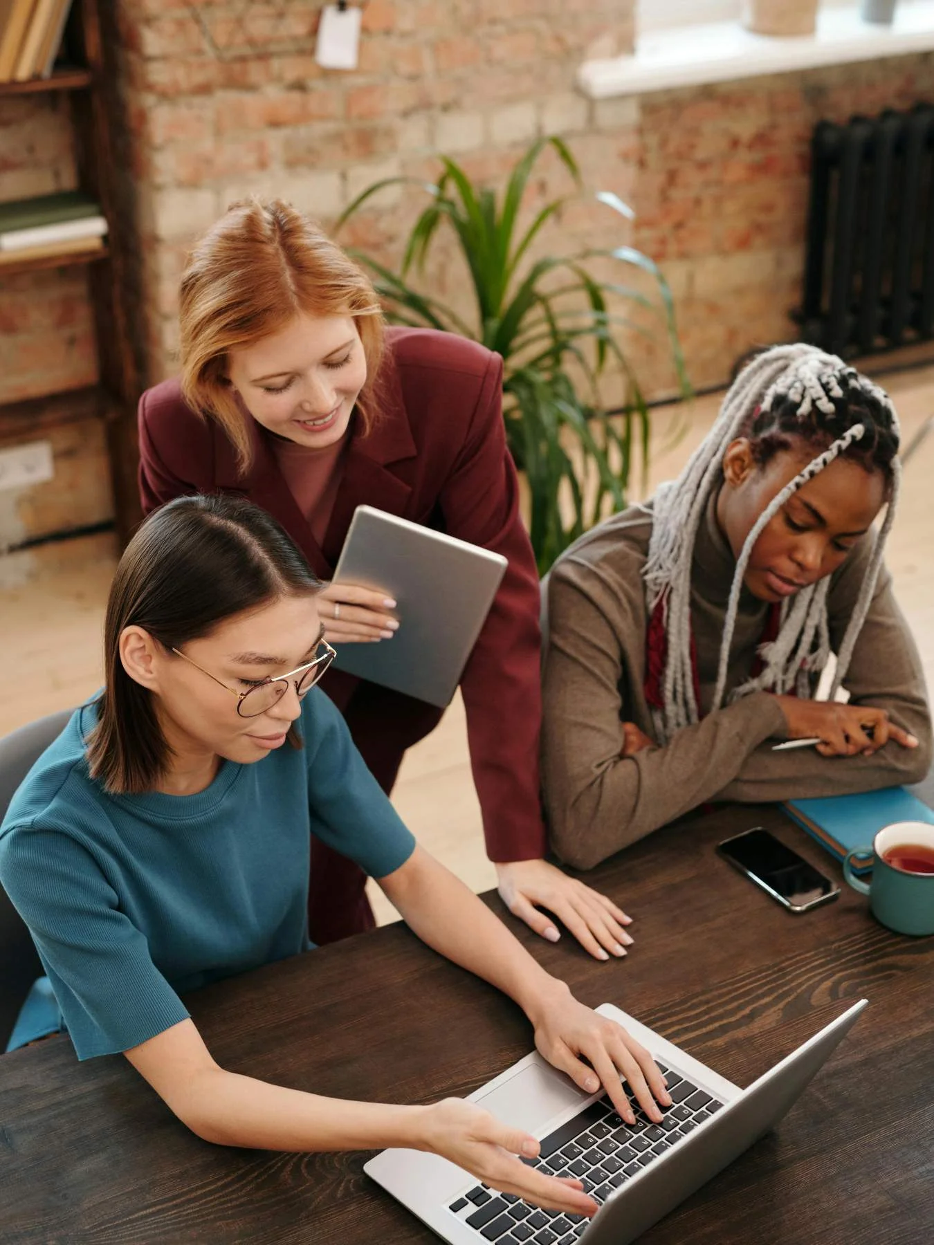 Team reviewing Shopify store design on laptop during development session
