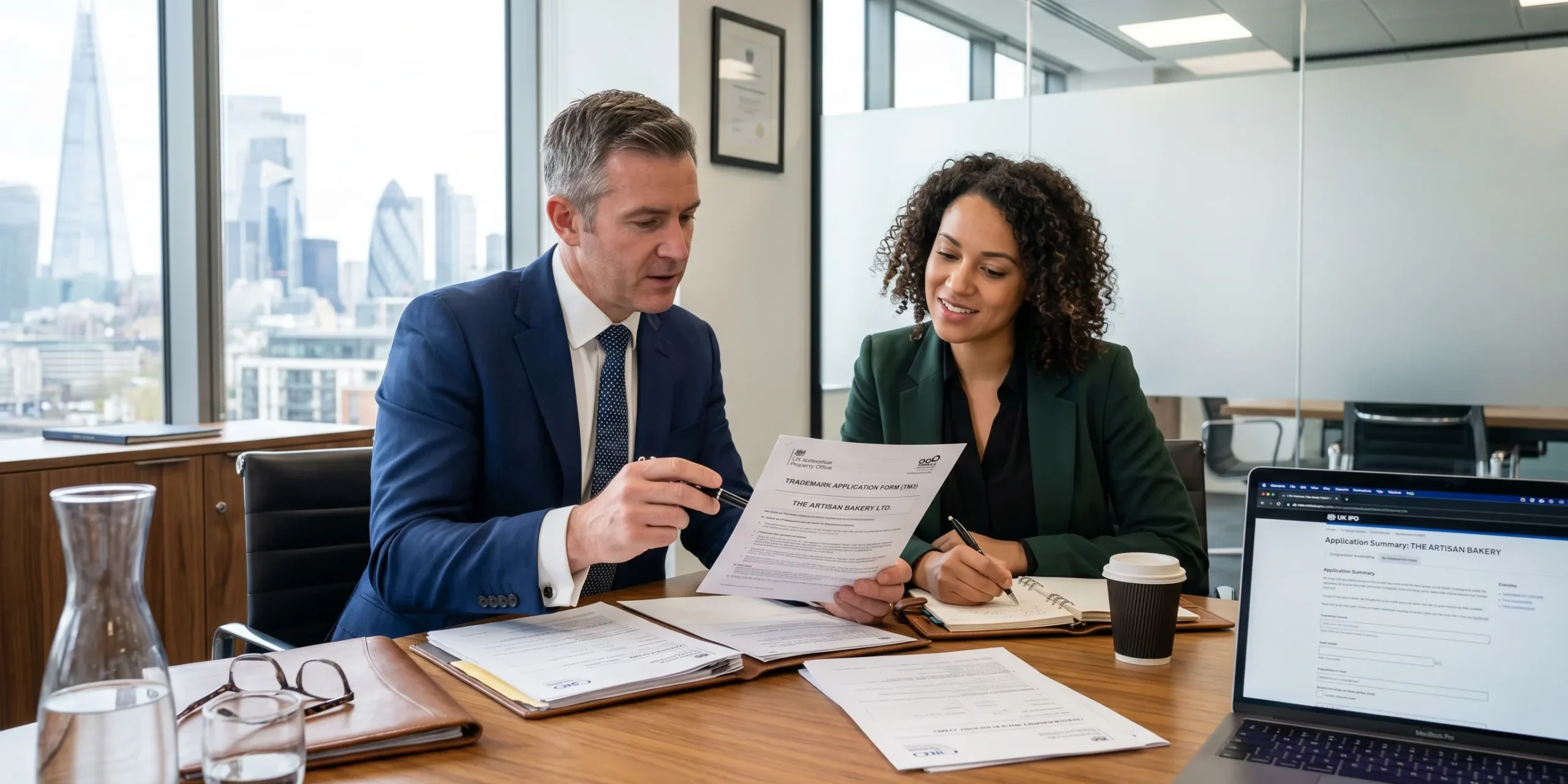 A1 UK Trademark Registration Guide blog – Hero Banner Business consultant helping a company owner complete UK trademark registration documents in a modern office.